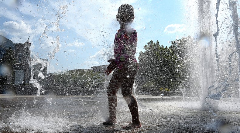 Paulina Lopez, 4, plays in the Big Splash fountain at Town Center Park on Wednesday, Sept. 2, 2026, in Suwanee. The National Weather Service predicts hot and humid conditions for the long Labor Day weekend. (Hyosub Shin/AJC)