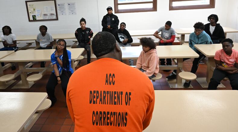 Marcus Lawson (foreground, center), an inmate at the Athens-Clarke County Correctional Institution, speaks to students inside the prison Saturday, May 16, 2026, in Athens. "Don't do to your mama what I did to mine," said Lawson, who was sentenced to 30 years for numerous offenses related to the robbery of taxicab drivers. (Hyosub Shin/AJC)