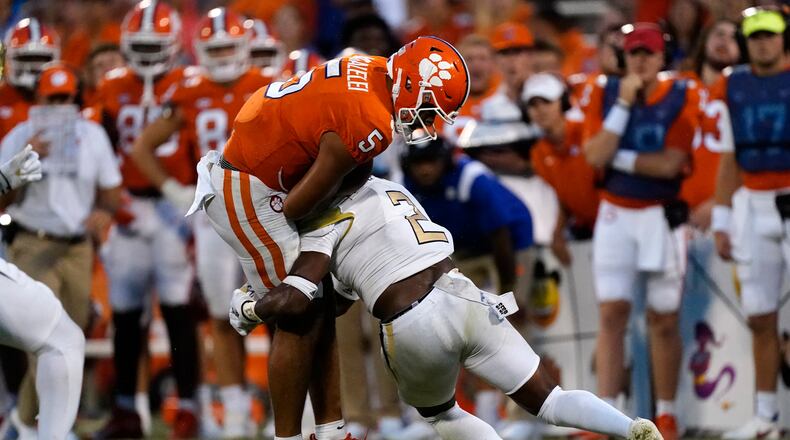 Clemson quarterback D.J. Uiagalelei (5) is hit by Georgia Tech defensive back Tariq Carpenter (2) after a short gain in the second half of an NCAA college football game, Saturday, Sept. 18, 2021, in Clemson, S.C. (AP Photo/John Bazemore)