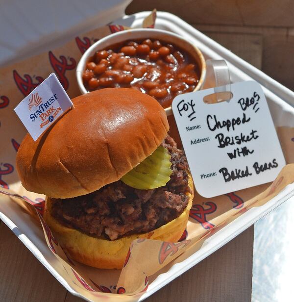 The Fox Bros. chopped brisket sandwich at SunTrust Park comes with baked beans (shown) or coleslaw. You’ll find Fox Bros. food in the Terrapin Taproom and in Section P152. CHRIS HUNT / SPECIAL