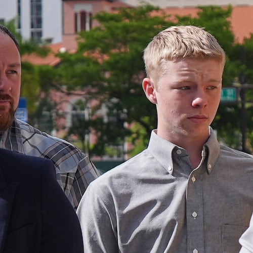 Timothy Hudson, center, charged with sexually assaulting and killing his 18-year-old stepsister on a Carnival Cruise ship, arrives for a hearing at the The James Lawrence King Federal Justice Building, Wednesday, May 27, 2026, in Miami. (AP Photo/Rebecca Blackwell)