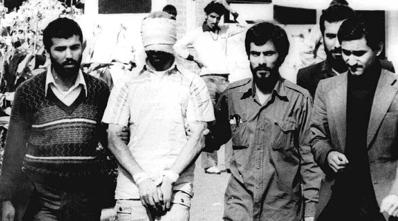 In this Nov. 9, 1979, photo, one of the hostages being held at the U.S. Embassy in Tehran is displayed to the crowd. AP Photo.