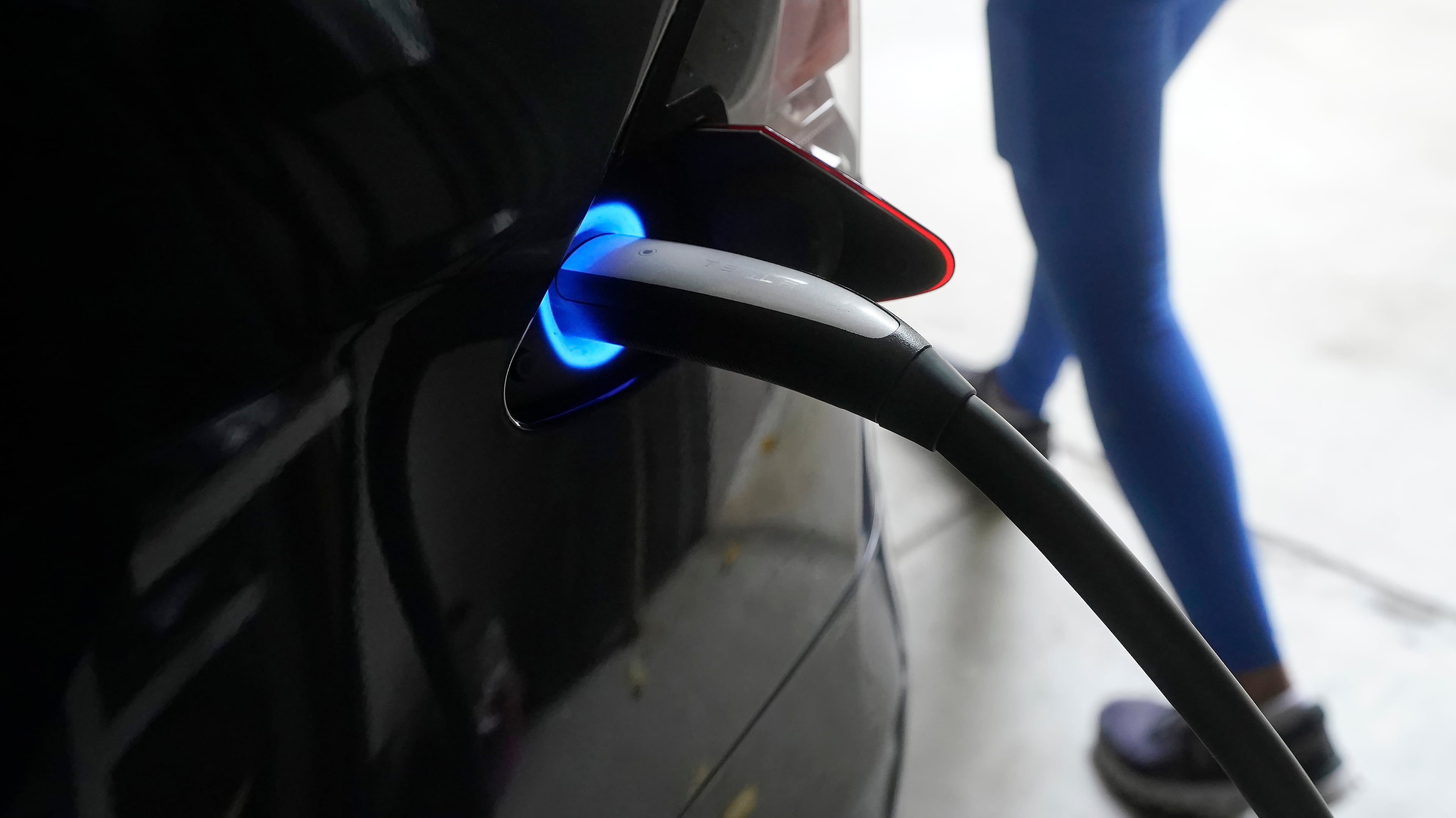 FILE - A Tesla car charges at a home in San Francisco, Aug. 25, 2022. (AP Photo/Jeff Chiu, File)