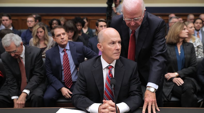 Former U.S. Sen. Saxby Chambliss, R-Ga., talks with ex-Equifax CEO Richard Smith before he testifies to a House Energy and Commerce Committee panel on October 3, 2017. (Photo by Chip Somodevilla/Getty Images)