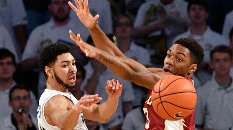 Georgia Tech guard Josh Heath, left, passes as Florida State guard Trent Forrest (3) defends during the first half of an NCAA basketball game, Wednesday, Jan. 25, 2017, in Atlanta. (AP Photo/John Amis)