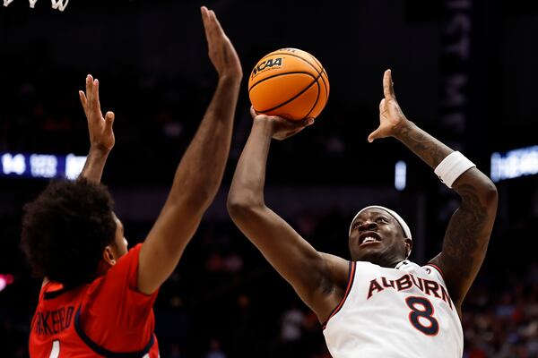 Auburn forward Ja'Heim Hudson (8) shoots against Mississippi forward Jaemyn Brakefield (4) during the first half of an NCAA college basketball game in the quarterfinal round of the Southeastern Conference tournament, Friday, March 14, 2025, in Nashville, Tenn. (AP Photo/Wade Payne)