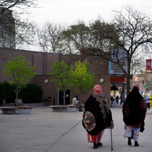 FILE - Women walk down a street in the predominantly Somali neighborhood of Cedar-Riverside in Minneapolis on May 12, 2022. (AP Photo/Jessie Wardarski, File)