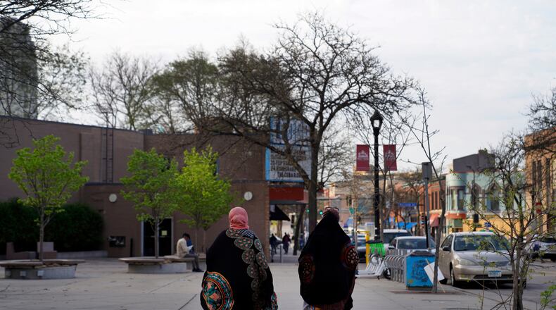 FILE - Women walk down a street in the predominantly Somali neighborhood of Cedar-Riverside in Minneapolis on May 12, 2022. (AP Photo/Jessie Wardarski, File)
