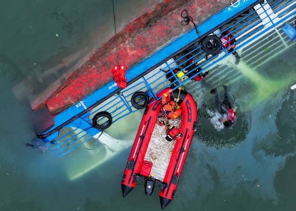 In this photo released by Xinhua News Agency, rescuers conduct a search and rescue operation at one of the two passenger boats capsized in Qianxi City, southwest China's Guizhou Province on Monday, May 5, 2025. (Liu Xu/Xinhua via AP)