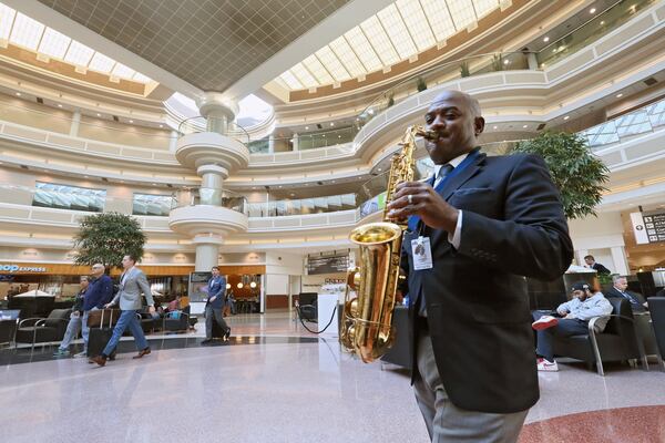 Dwan Bosman performs on sax in the domestic terminal atrium. Hartsfield-Jackson hires live musicians to calm and entertain travelers in the terminal and on the concourses. BOB ANDRES /BANDRES@AJC.COM