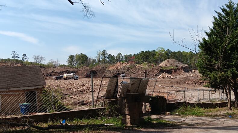 Contractors clean up a years-old illegal landfill at 7365 Bishop Road in South Fulton on March 21. The land sold in June 2023 and the new owner plans to use it as a storage site.