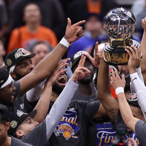 The New York Knicks hold the Eastern Conference Championship trophy after Game 4 in the Eastern Conference finals NBA basketball playoffs series against the Cleveland Cavaliers in Cleveland, Monday, May 25, 2026. (AP Photo/Tim Phillis)
