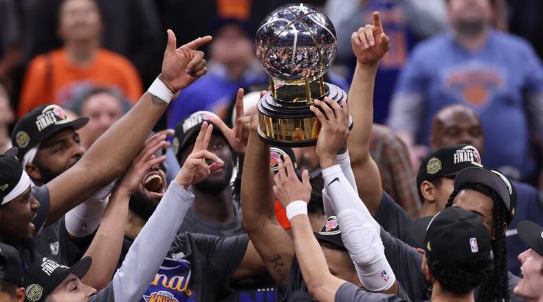 The New York Knicks hold the Eastern Conference Championship trophy after Game 4 in the Eastern Conference finals NBA basketball playoffs series against the Cleveland Cavaliers in Cleveland, Monday, May 25, 2026. (AP Photo/Tim Phillis)