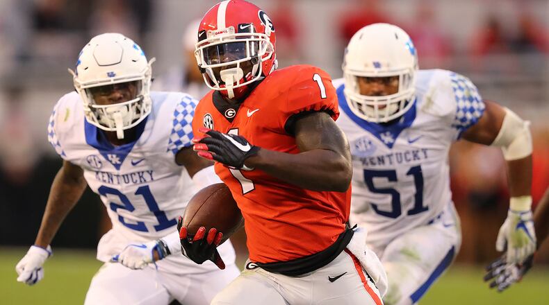 November 18, 2017 Athens: Georgia tailback Sony Michel breaks away from Kentucky defenders for a touchdown to take a 21-6 lead during the second quarter in a NCAA college football game on Saturday, November 18, 2017, in Athens. Curtis Compton/ccompton@ajc.com