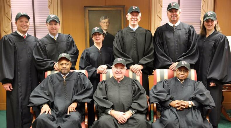 State Supreme Court justices cheer for Falcons. Front row from left: Harold Melton, Harris Hines and Robert Benham. Back row from left: Nels Peterson, Keith Blackwell, Carol Hunstein, David Nahmias, Michael Boggs and Britt Grant. (Photo courtesy of the Georgia Supreme Court)