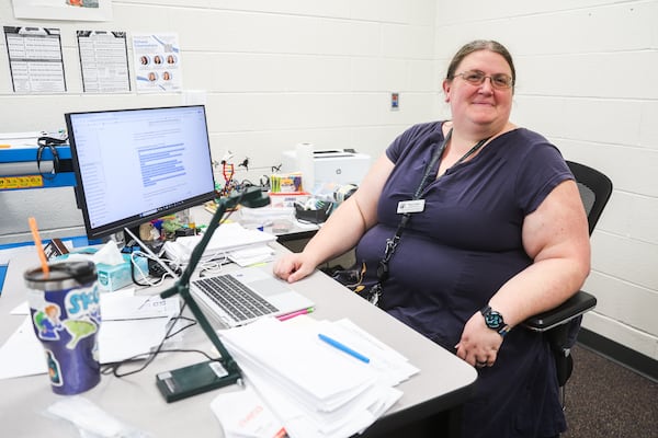 AI teacher Holly Hall sits at her desk as she asks ChatGPT to write reflection questions for her students at Seckinger High School in Buford, Georgia, on Tuesday, Aug. 5, 2025. (Abbey Cutrer/AJC)