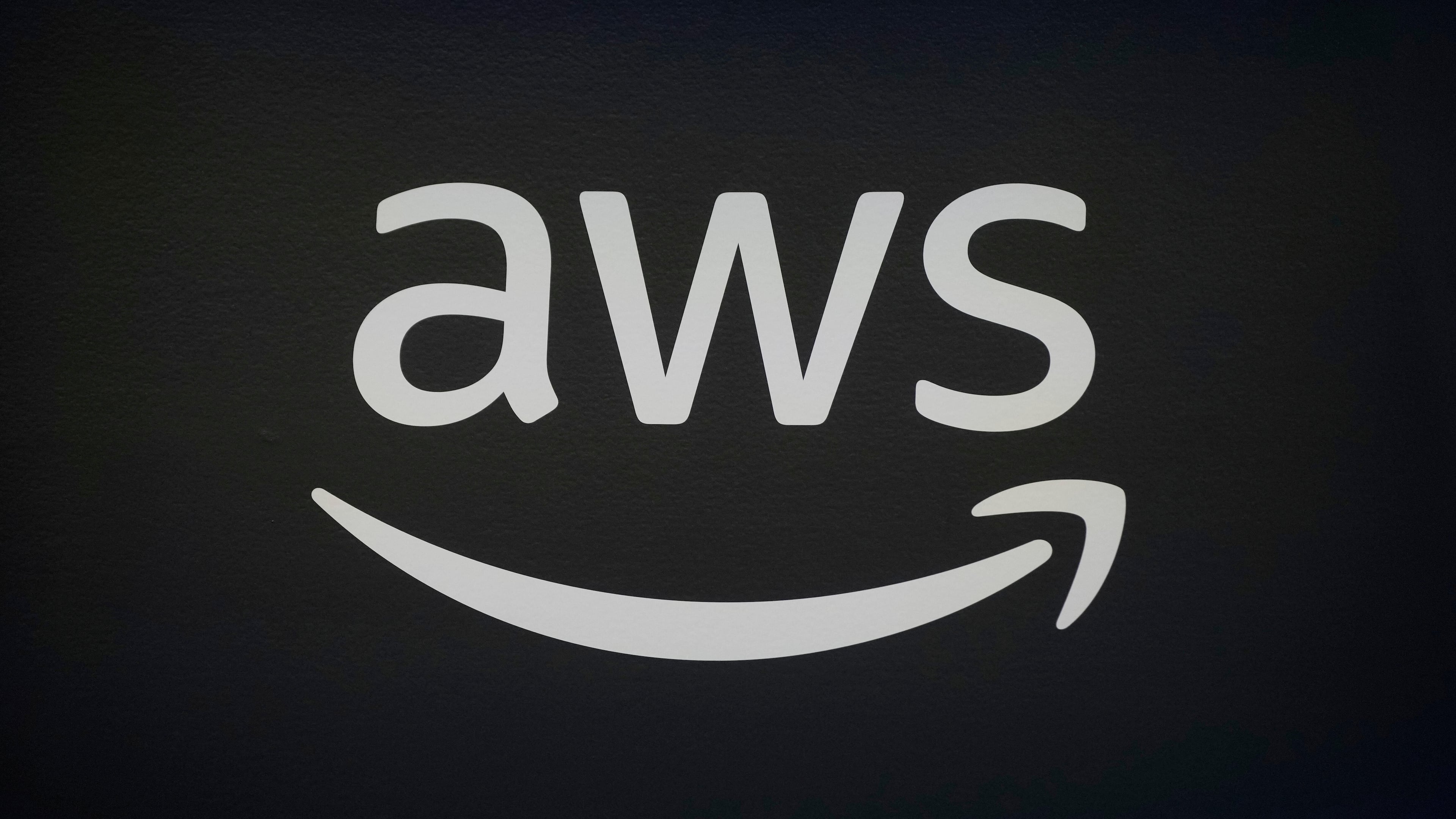 FILE - An AWS, Amazon Web Services, logo is displayed at LlamaCon 2025, an AI developer conference, in Menlo Park, Calif., Tuesday, April 29, 2025. (AP Photo/Jeff Chiu, File)