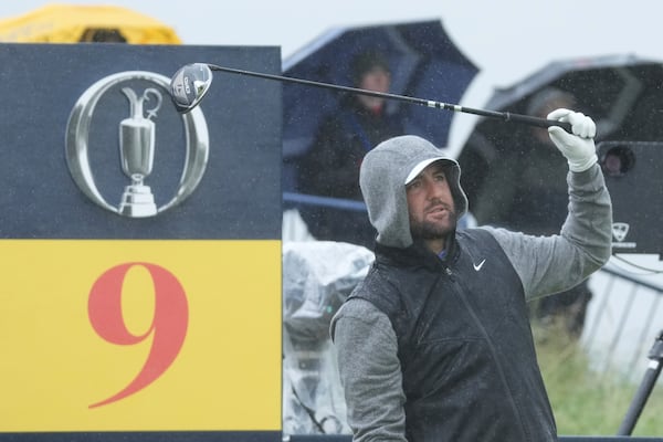 Scottie Scheffler of the United States races after hitting his drive on the 9th tee during a practice round for the British Open golf championship at the Royal Portrush Golf Club, Northern Ireland, Tuesday, July 15, 2025. (AP Photo/Jon Super)