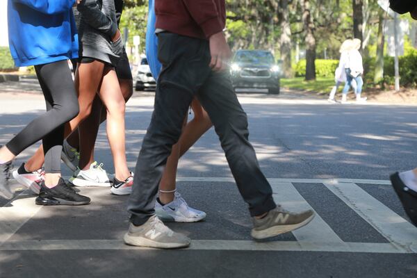 A group of pedestrians cross Oglethorpe Avenue on Bull Street.