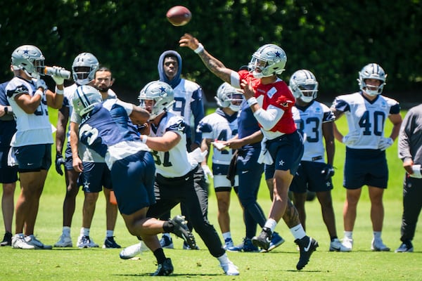 Dallas Cowboys' Dak Prescott throws the football during NFL football practice at the Cowboys facility, Tuesday, May 20, 2025, in Frisco, Texas. (AP Photo/Jessica Tobias)