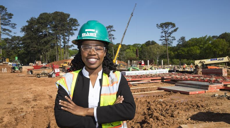 New South Construction project manager Olivia Fru poses for a portrait at the construction site for Peachtree Hills Place, a 55+ living community in the Peachtree Hills Atlanta neighborhood , Wednesday. Fru, a graduate from Southern Polytechnic State University, says she became interested in construction at a young age. She says she enjoyed watching structures go up while living in Camaroon. “It’s like playing Lego,” says Olivia. ALYSSA POINTER/ALYSSA.POINTER@AJC.COM