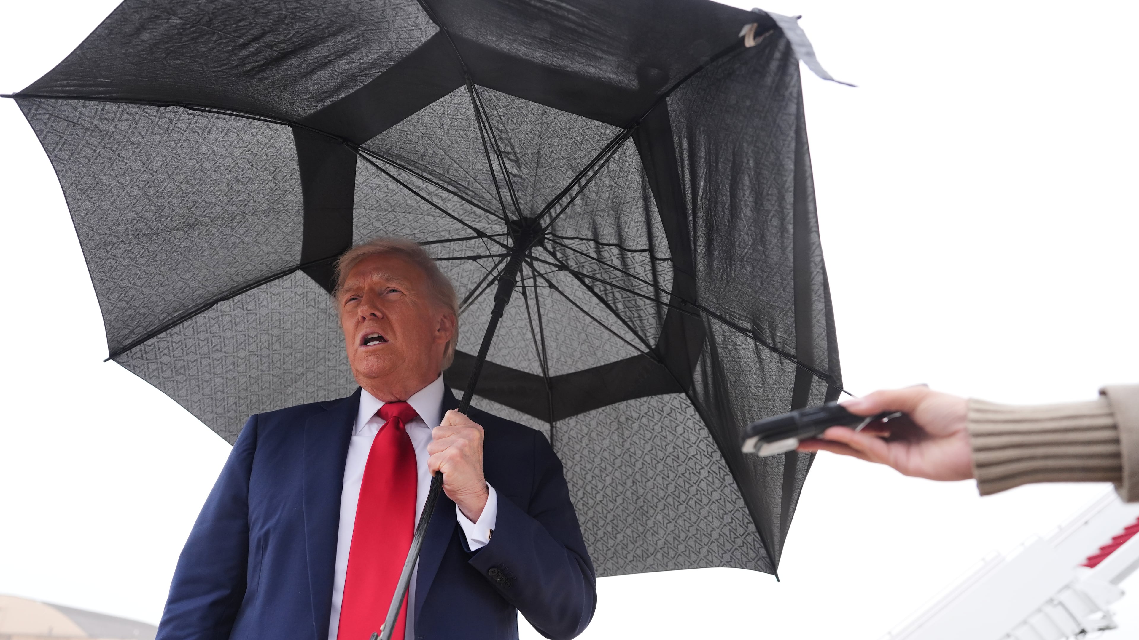 President Donald Trump speaks with reporters before boarding Air Force One, Sunday, Oct. 12, 2025, at Joint Base Andrews, Md., as he heads to the Middle East. (AP Photo/Evan Vucci)