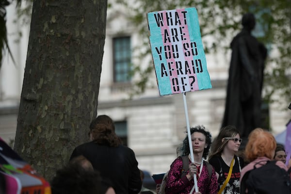 Campaigners take part in a rally organised by trans rights groups, trade unions, and community organisations following the Supreme Court ruling on the definition of a woman in equalities law, at Parliament Square, central London, Saturday April 19, 2025. (AP Photo/Alastair Grant)