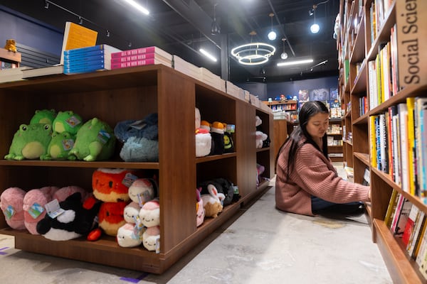 Owner Lindsi Bollinger organizes books at Offbeat Books in the Peoplestown neighborhood. (Arvin Temkar/AJC)