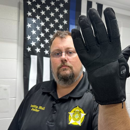 Nelson County, Ky., jailer Justin Hall shows an electric shock glove that is used at his facility, Thursday, Aug. 13, 2026, in Bardstown, Ky. (AP Photo/Dylan Lovan)
