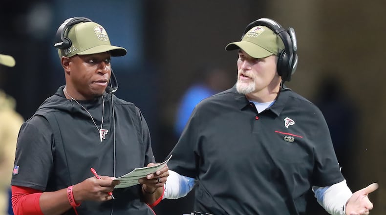 Falcons assistant Raheem Morris confers with head coach Dan Quinn during a November game against Tampa Bay last season. (Curtis Compton/ccompton@ajc.com)