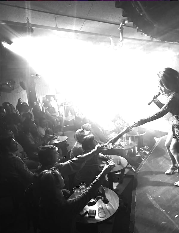 A performer accepts tips from audience members in the now-former home of Club One in Savannah.