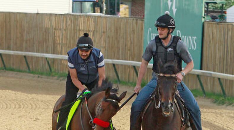 Kentucky Derby hopeful Nyquist, left, under exercise rider Jonny Garcia, walks the track at Churchill Downs in Louisville, Ky., Monday, May 2, 2016. At right is assistant trainer Jack Sisterson. The 142nd Kentucky Derby is Saturday, May 7. (AP Photo/Garry Jones)