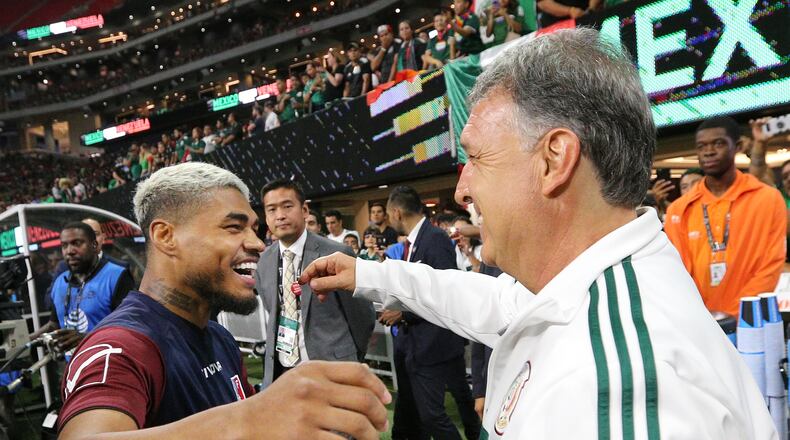 Former Atlanta United head coach Gerardo Martino and Josef Martinez embrace as they meet on the pitch before Mexico played Venezuela on June 5, 2019 in Atlanta. Martinez, an Atlanta United star, played for Venezuela.  Curtis Compton/ccompton@ajc.com