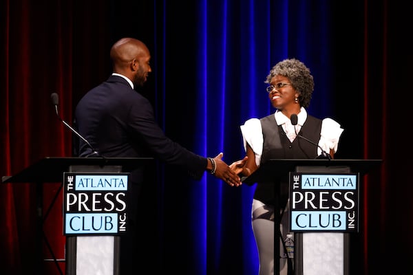 (L-R) Democratic candidates for Congress Everton Blair and Jasmine Clark shake hands after the Atlanta Press Club Loudermilk-Young District 13 debate at Georgia Public Broadcasting in Atlanta on April 27, 2026. (Arvin Temkar/AJC)
