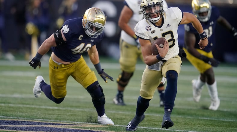 Georgia Tech quarterback Jordan Yates (13) is chased by Notre Dame's Drew White (40) during the second half of an NCAA college football game, Saturday, Nov. 20, 2021, in South Bend, Ind. Notre Dame won 55-0. (AP Photo/Darron Cummings)