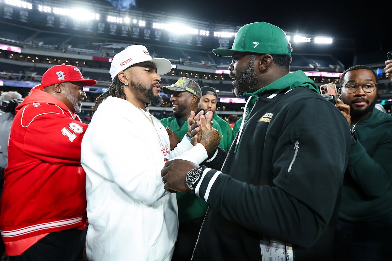 Delaware State head coach DeSean Jackson (center) shakes hands with Norfolk State head coach Michael Vick (right) after the game at Lincoln Financial Field on Oct. 30, 2025, in Philadelphia. Both head coaches had previously played for the Philadelphia Eagles. (Isaiah Vazquez/Getty Images/TNS)