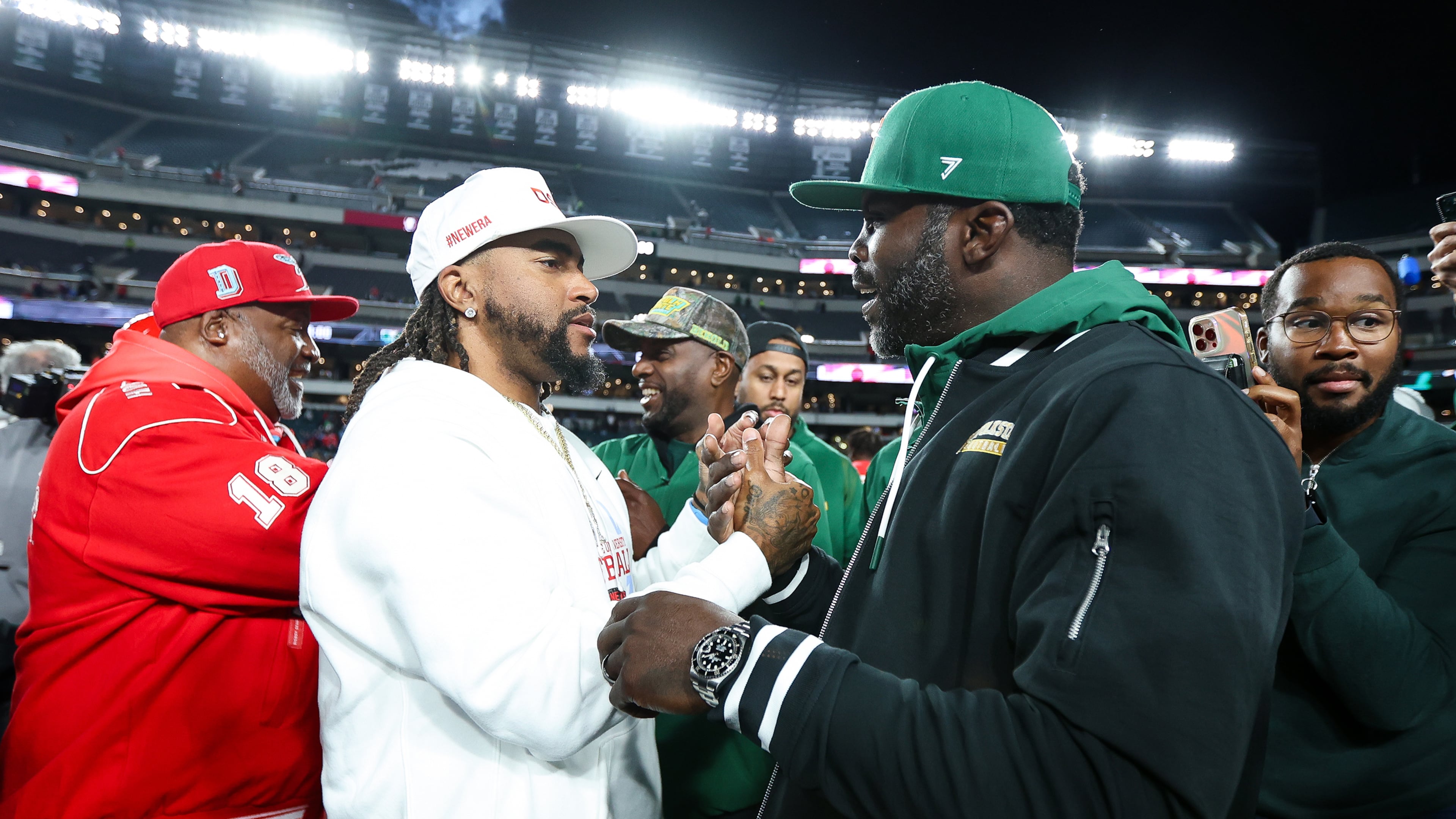 Delaware State head coach DeSean Jackson (center) shakes hands with Norfolk State head coach Michael Vick (right) after the game at Lincoln Financial Field on Oct. 30, 2025, in Philadelphia. Both head coaches had previously played for the Philadelphia Eagles. (Isaiah Vazquez/Getty Images/TNS)