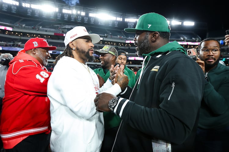Delaware State head coach DeSean Jackson (center) shakes hands with Norfolk State head coach Michael Vick (right) after the game at Lincoln Financial Field on Oct. 30, 2025, in Philadelphia. Both head coaches had previously played for the Philadelphia Eagles. (Isaiah Vazquez/Getty Images/TNS)
