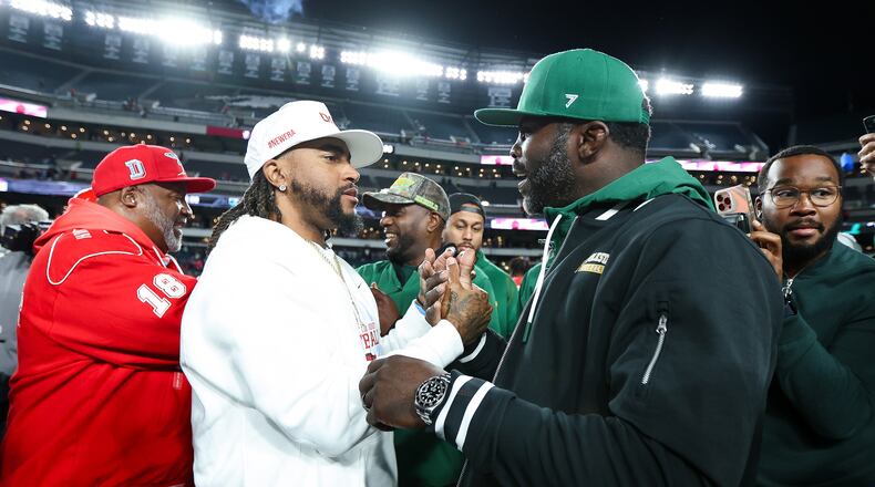 Delaware State head coach DeSean Jackson (center) shakes hands with Norfolk State head coach Michael Vick (right) after the game at Lincoln Financial Field on Oct. 30, 2025, in Philadelphia. Both head coaches had previously played for the Philadelphia Eagles. (Isaiah Vazquez/Getty Images/TNS)