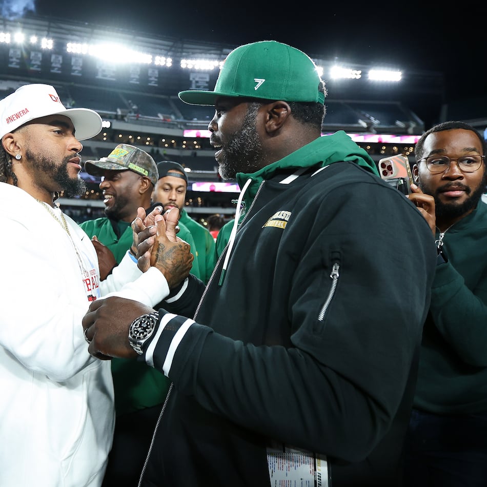 Delaware State head coach DeSean Jackson (center) shakes hands with Norfolk State head coach Michael Vick (right) after the game at Lincoln Financial Field on Oct. 30, 2025, in Philadelphia. Both head coaches had previously played for the Philadelphia Eagles. (Isaiah Vazquez/Getty Images/TNS)