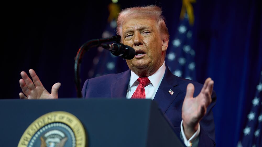 President Donald Trump, seen here addressing House Republicans during their annual policy retreat Tuesday, says he’s entitled to compensation under a new Georgia law because the Fulton County District Attorney who prosecuted him was thrown off the case, which was subsequently tossed. (Evan Vucci/AP)