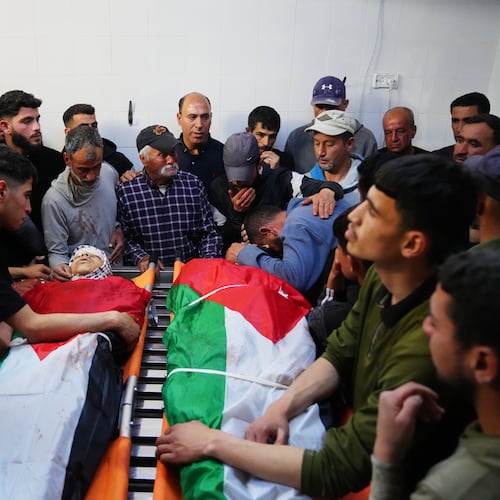 Mourners gather around the bodies of Aws al-Na'san and Jihad Abu Naim, residents of the West Bank village of al-Mughayyir, at the hospital's morgue in the West Bank city of Ramallah, Tuesday, April 21, 2026. (AP Photo/Mahmoud Illean)