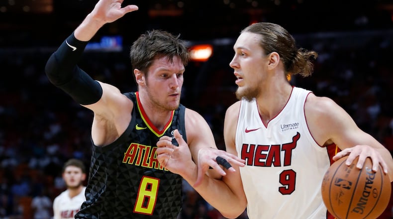 Miami Heat forward Kelly Olynyk (9) drives past Atlanta Hawks forward Luke Babbitt (8) during the first half of an NBA basketball game Monday, Oct. 23, 2017, in Miami. (AP Photo/Wilfredo Lee)