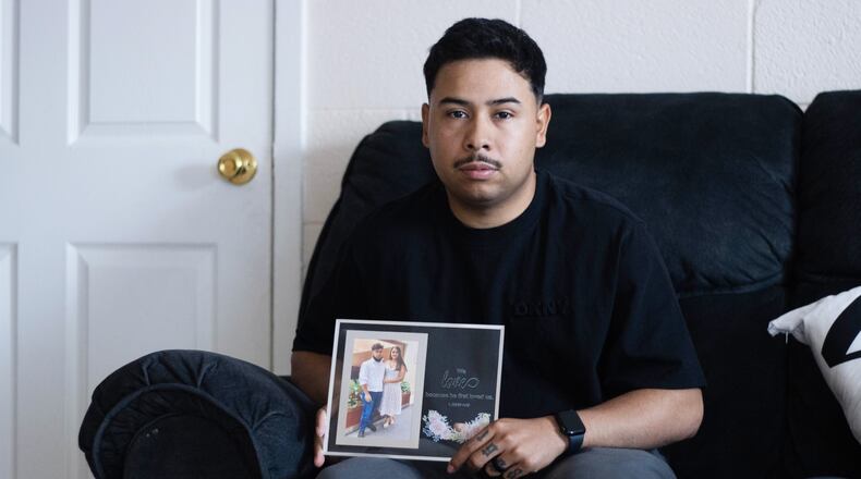 FILE - Army Sgt. Hedar Leonel Turcios Juarez holds a picture of himself with with his wife Cristy at home in El Paso, Texas, July 21, 2026. (AP Photo/Ryan Romero, File)