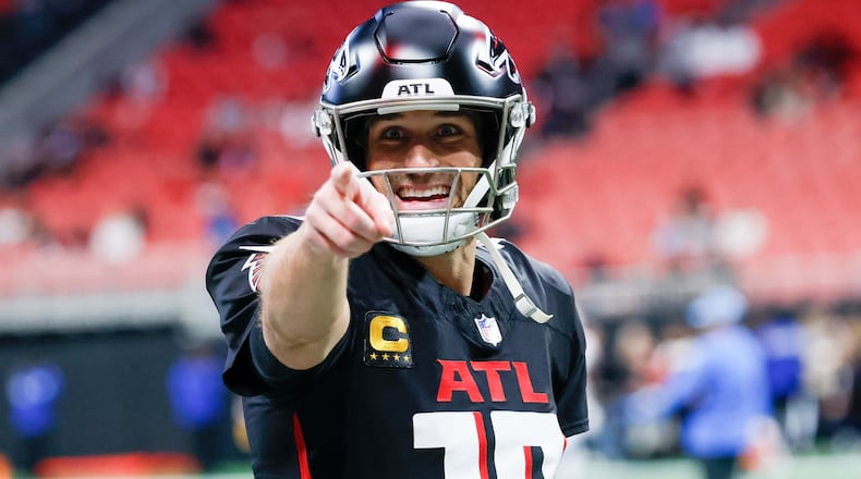 Falcons quarterback Kirk Cousins signals to the fans during warm-ups before facing the Los Angeles Chargers on Sunday at Mercedes-Benz Stadium in Atlanta.
(Miguel Martinez/ AJC)