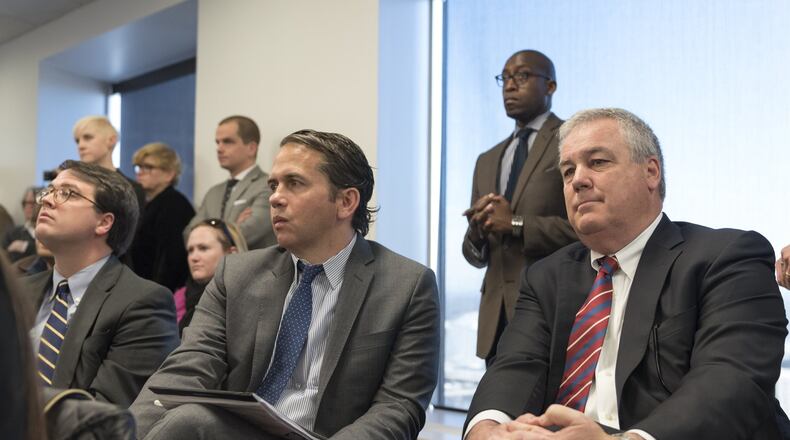 March 16, 2017, Atlanta - WRS Real Estate Investments President and CEO Scott Smith, right, and development officer Kevin Rogers, center, react to the approval of the sale of Underground Atlanta during an Invest Atlanta board meeting in Atlanta, Georgia, on Thursday, March 16, 2017. (DAVID BARNES / SPECIAL)