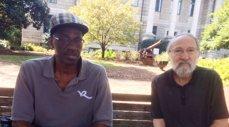 Melvin Brown (left) and Derek Miller were having a discussion on race just before Atlanta Journal-Constitution reporter Bill Torpy stumbled upon them in downtown Decatur. The city is weighing kicking off an expensive series of roundtable talks on the touchy subject. BILL TORPY BTORPY@AJC.COM