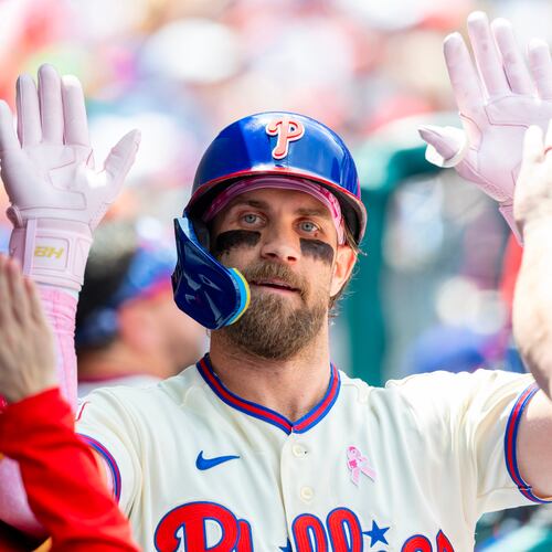 Philadelphia Phillies' Bryce Harper is congratulated in the dugout after he hit a solo home run in the first inning of a baseball game against the Colorado Rockies, Sunday, May 10, 2026, in Philadelphia. (AP Photo/Laurence Kesterson)