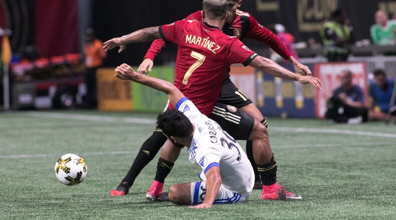 Atlanta United forward Josef Martinez (7), center, Atlanta United midfielder Yamil Asad (11), partially seen, and Montreal Impact defender Victor Cabrera (36) fight over the ball during the second half of a MLS soccer game at Mercedes-Benz Stadium, Sunday, Sept. 24, 2017, in Atlanta. BRANDEN CAMP/SPECIAL