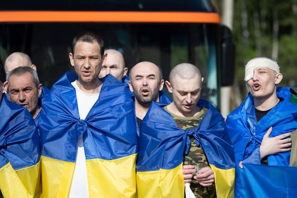 In this photo provided by the Ukrainian Presidential Press Office, Ukrainian soldiers react after returning from captivity during a prisoners' exchange between Russia and Ukraine, in Chernyhiv region, Ukraine, Tuesday, June 10, 2025. (Ukrainian Presidential Press Office via AP)